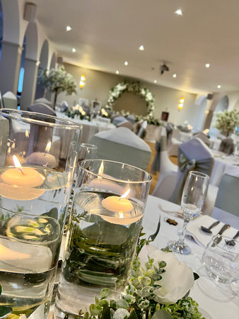 wedding table decoration with candles in a restaurant, close upの写真素材