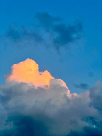 Clouds in the blue sky at sunset as an abstract background.の写真素材