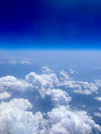 clouds in the blue sky, view from the window of an aircraftの写真素材