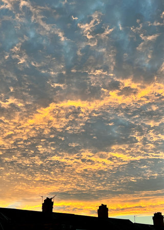 Cloudscape, Colored Clouds at Sunset near the Ocean on a Cloudy Dayの写真素材