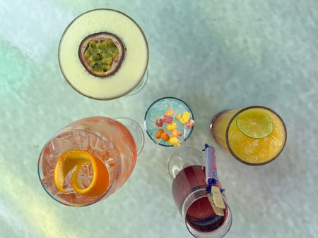 Alcoholic cocktails with passion fruit, orange, lemon and ice on a white backgroundの写真素材