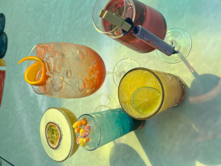Alcoholic cocktails with fruits and ice on the table in a restaurantの写真素材