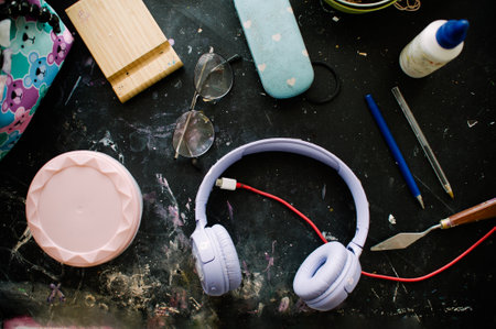 Back to school concept with headphones and stationery on blackboard background