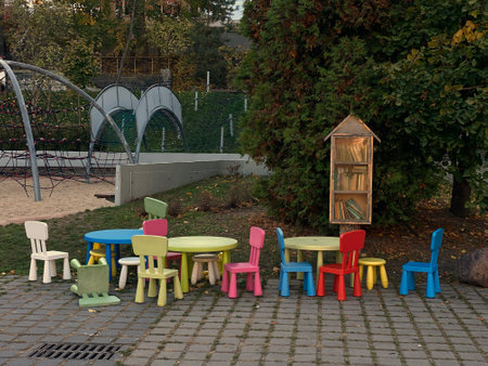 The photo shows a colorful childrens seating area with small chair and tables in a park.の写真素材