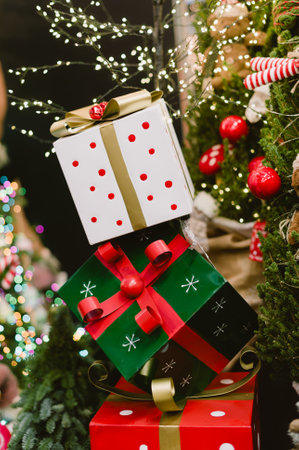 A stack of boxes with a red bow on top. The boxes are stacked on top of each other