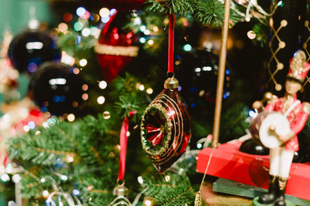 A Christmas tree with many ornaments on it. The tree is lit up with lights. There are many different colored ornaments on the treeの写真素材