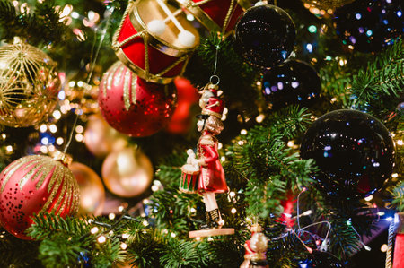 A Christmas tree with a red and gold drum and a green and gold soldier. The tree is lit up with lightsの写真素材