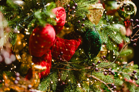 A Christmas tree with red and green ornaments. The red ornaments are hearts and the green ones are bellsの写真素材