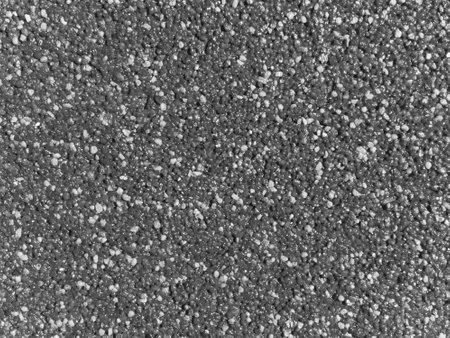 A black and white photo of a rock surface. The surface is covered in small rocks. The rocks are of various sizes and are scattered all over the surfaceの写真素材