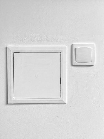 A white box with a white switch on it. The switch is on the right side of the boxの写真素材