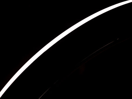 A black and white photo of a line. The line is white and is on the left side of the photo