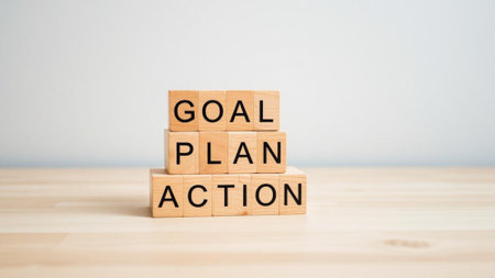 A stack of wooden blocks with the words goal plan action written on them. The blocks are arranged in a pyramid shapeの写真素材
