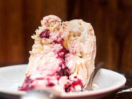 Stock photo showing an elevated view of a homemade Black Forest gateau displayed against a marble...