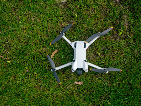 White drone is on the grass. The drone is on the ground and is not flyingの写真素材