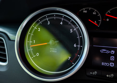 High resolution close up of a modern car tachometer showing revolutions per minute (RPM) in a...