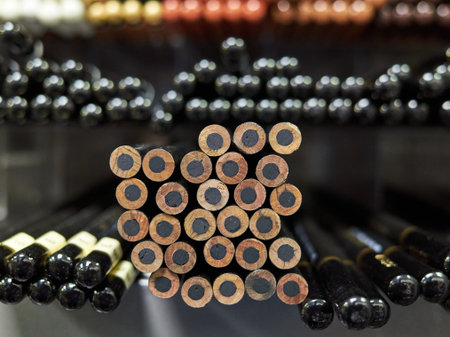 Bunch of pencils with black tips and a black center. Some are sharpened and some are not