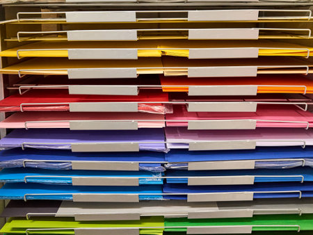 Rack of colored paper is on display. The rack is full of paper in a variety of colors