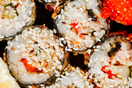 Various kinds of hot fried sushi rolls served on table. Macro shotの写真素材