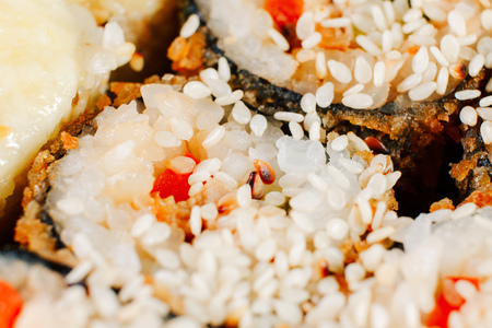 Various kinds of hot fried sushi rolls served on table. Macro shotの写真素材