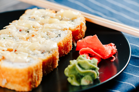 Various kinds of hot fried sushi rolls served on tableの写真素材