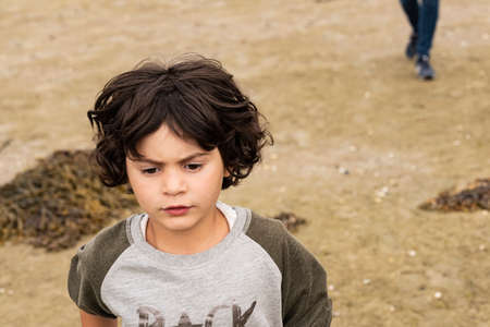 portrait during travel of white caucasian girl with short hair. with cliff and forest in background.の写真素材