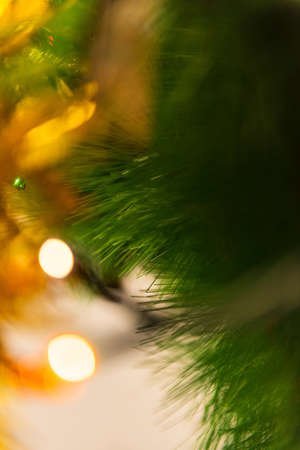 detail with selective focus of coloured lights on the christmas treeの写真素材