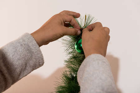detail hands decorating christmas tree on hollidaysの写真素材