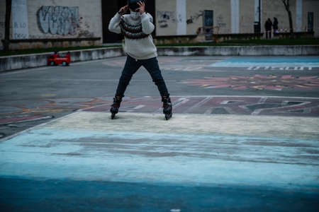 Caucasian boy practises roller skating in a city parkの写真素材