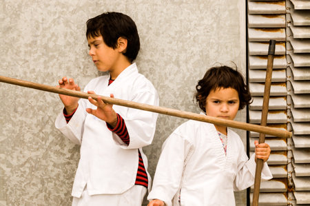 portrait of two children play karate in wall backgroundの写真素材