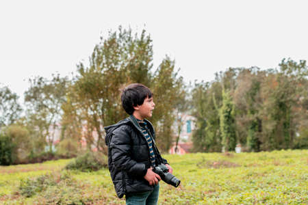 portrait of a child photographer in the woodsの写真素材