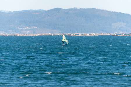 Illa de Arousa, Pontevedra, Spain - January 21, 2022: Kitesurfing specialists train for tournement.のeditorial素材