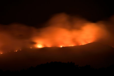 Illa de Arousa, Pontevedra, Spain. August 5, 2022: fire the mountains in Arosaのeditorial素材