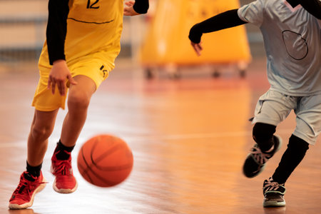 boys playing a game of indoor basketball.の写真素材