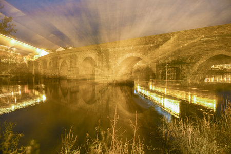 night landscape of the Roman bridge of Lugo over the Minho river. lightn zoom effect