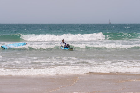 Sancti Petri, Cadiz, Spain. April 8th, 2023. Instructor with surfing students practicing on the beach at the Sancti Petri surf and kite surf club.のeditorial素材