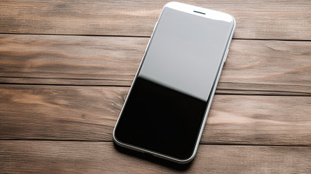 Smartphone with blank screen on wooden background. View from above.の素材