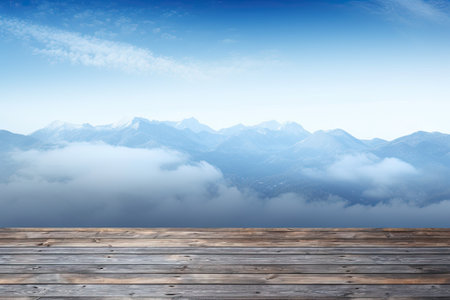 Wooden floor against blue sky over snowy mountain range with white cloudsの素材