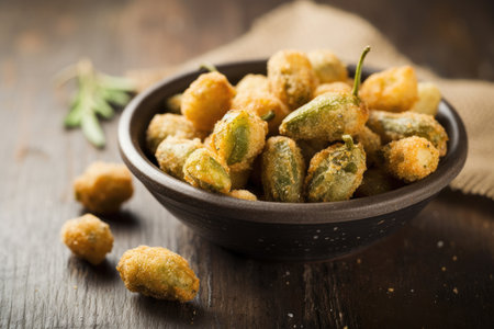 Crispy fried peanuts in bowl on wooden background. Selective focus.の素材