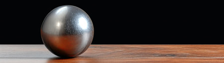 3d render of a metal ball on a wooden table with black backgroundの素材