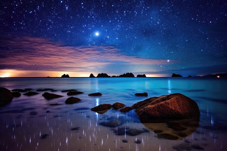 a beach with rocks and water and stars in the skyの素材
