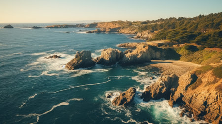 a rocky coastline with trees and a beach with Point Lobos in the backgroundの素材