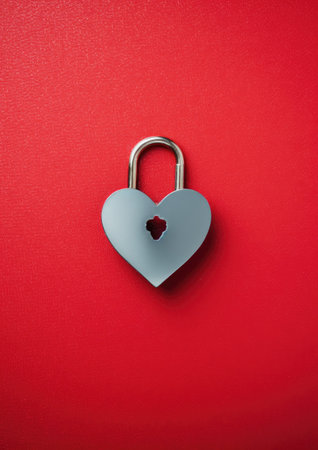a heart shaped lock on a red backgroundの素材