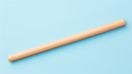 a wooden pencil on a blue backgroundの素材