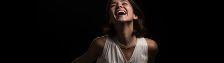 a woman laughing with her eyes closedの素材