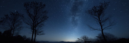 a starry sky over a mountain rangeの素材
