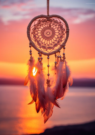 a dream catcher with feathers in the airの素材