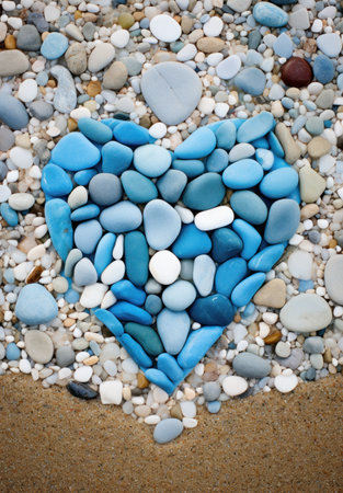 a heart shaped blue and white rocks on a beachの素材