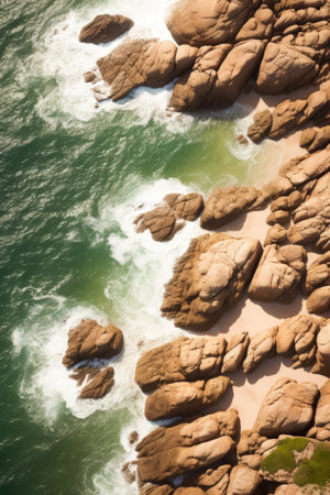 a rocky beach with waves crashing on itの素材