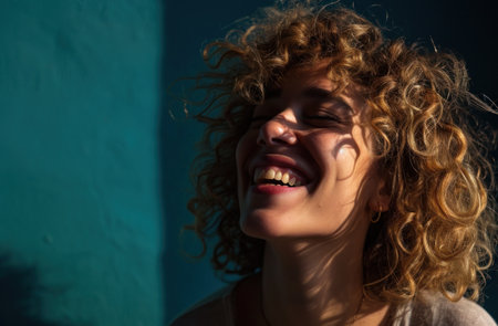 a woman smiling with her eyes closedの素材