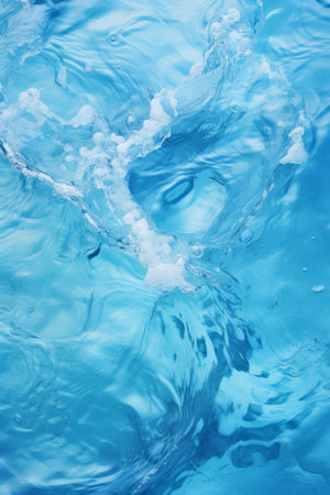 Abstract view of swirling blue water with light reflectionsの素材